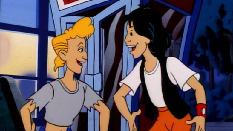 Bill and Ted smile with big grins as they stand in front of the time traveling phone booth in Bill & Ted's Excellent Adventures