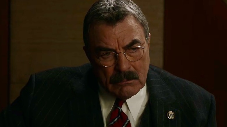 Frank Reagan looking serious while seated