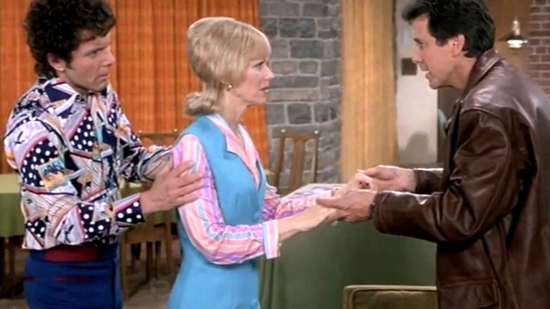 Carol Brady talking to Roy Martin with Mike standing nearby