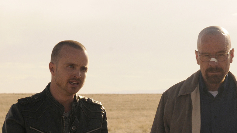 Tuco Salamanca (Raymond Cruz) stands right next to a kneeling Jimmy McGill (Bob Odenkirk) in "Better Call Saul"