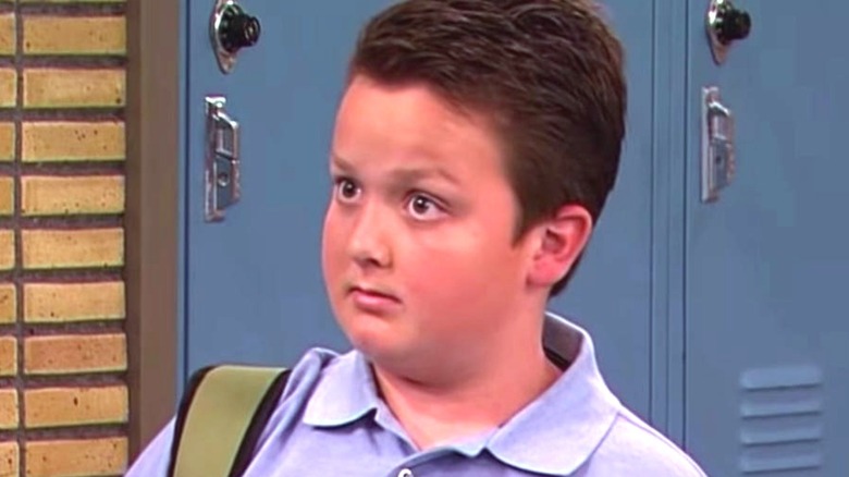 Orenthal Cornelius "Gibby" Gibson (Noah Munck) stands in front of the lockers at his high school on iCarly