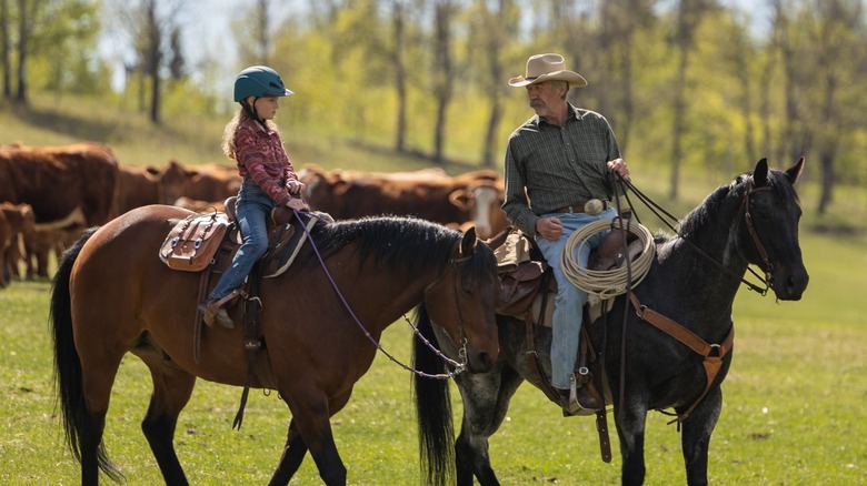 Lyndy Borden and Jack Bartlett riding horses on "Heartland"