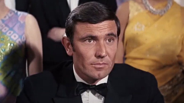 George Lazenby in a black tuxedo as James Bond.