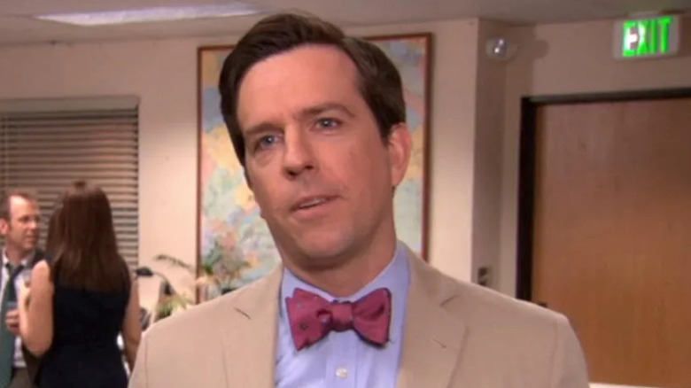 Ed Helms as Andy Bernard, smiling at the camera on The Office.