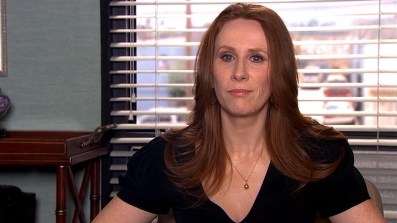 Catherine Tate as Nellie Bertram, sitting at her desk on The Office.