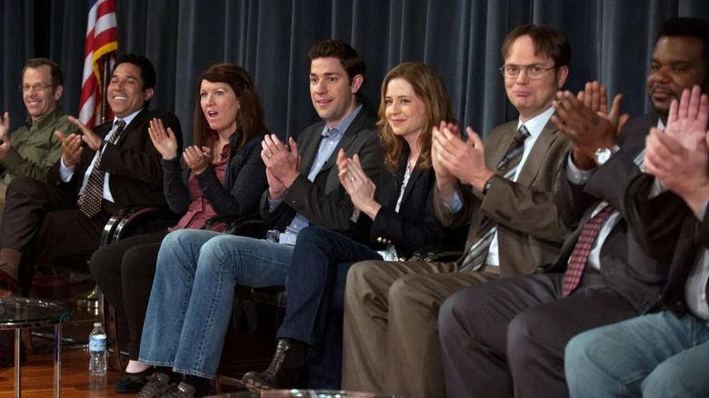 The employees of Dunder Mifflin reunite on a stage for a documentary panel on The Office.