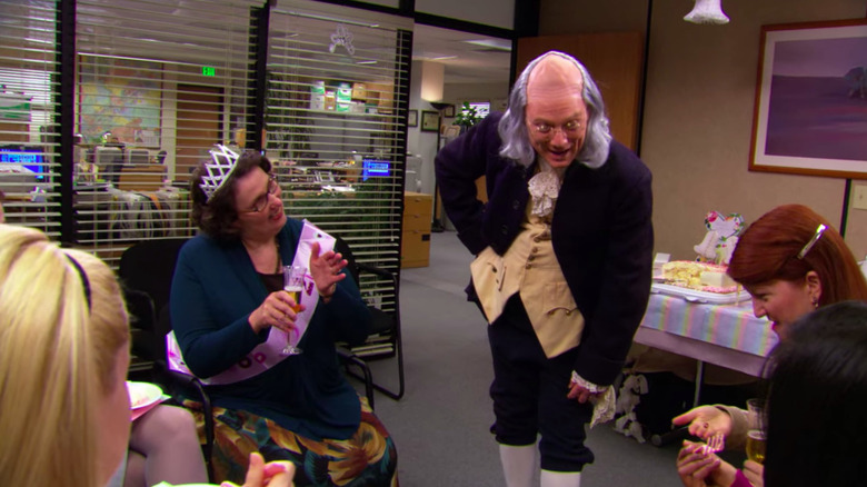 Ben Franklin (Andrew Daly) regales the office ladies in the conference room in The Office