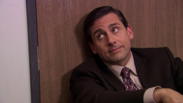 Michael Scott (Steve Carell) rests by a closed door in The Office