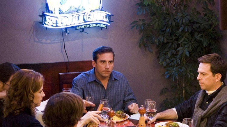 Michael Scott (Steve Carell) sits uncomfortably at a dinner table in The Office