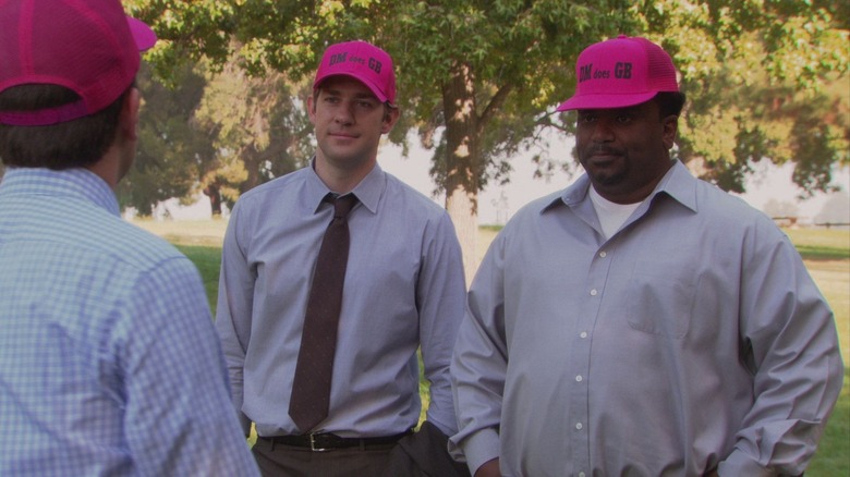John Krasinski as Jim Halpert stands next to Craig Robinson as Darryl Philbin in The Office