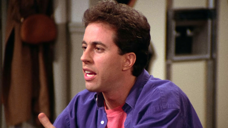 Jerry Seinfeld talking in purple shirt on Seinfeld
