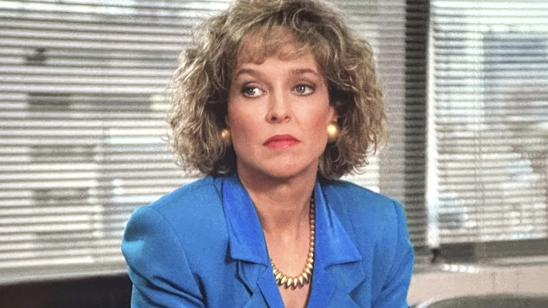 Ann Kelsey in a blue suit and gold necklace in L.A. Law