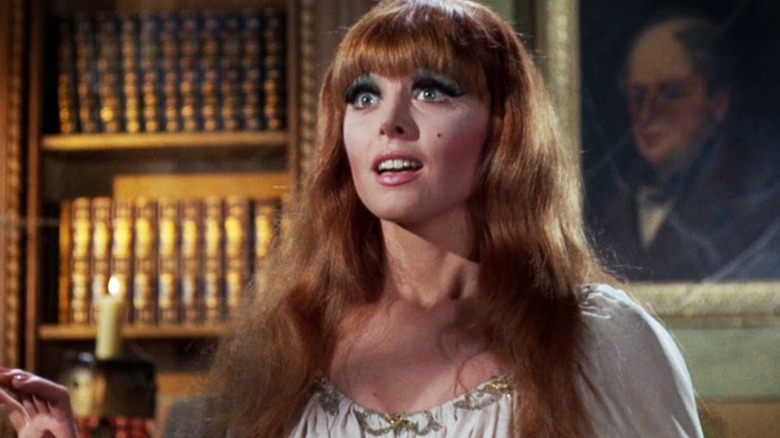 Tina Louise's Ginger stands in a library in Gilligan's Island