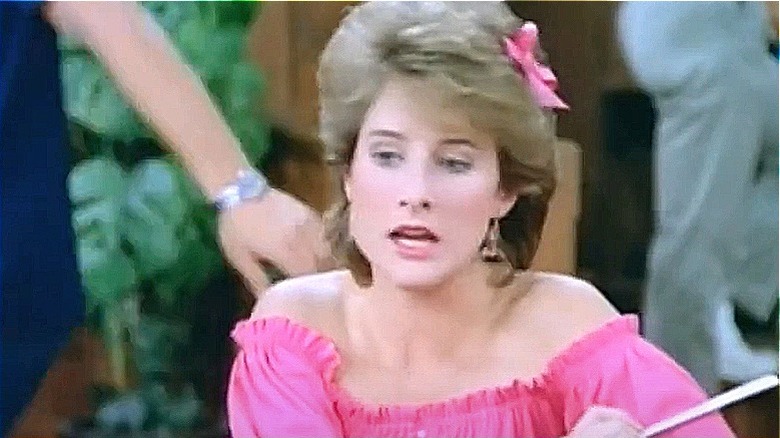 Jenny Piccalo in a pink blouse sits at a table