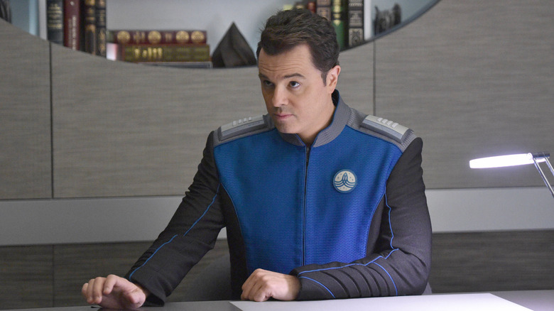 Captain Ed Mercer sitting at desk in quarters