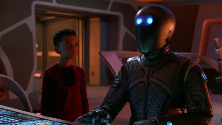 Ty looking at Isaac as he operates a control panel on The Orville S2E9