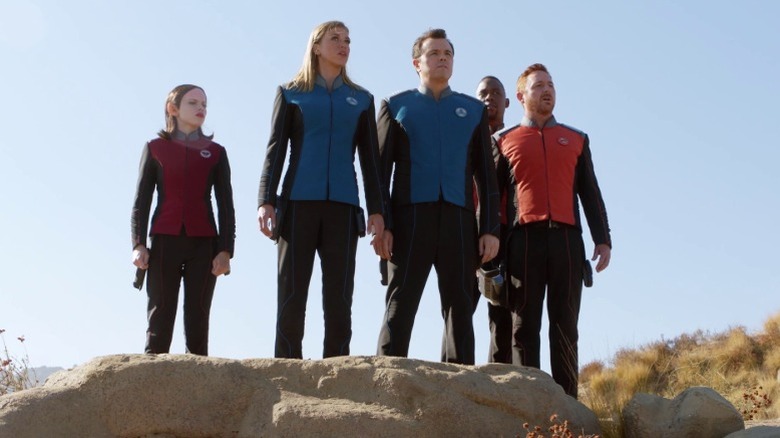 Alara, Kelly, Ed, John, and Gordon standing on a rock and staring out into the horizon on The Orville S1E12