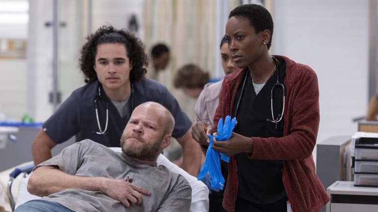 Nurse Mateo and Dr. Collins helping a patient