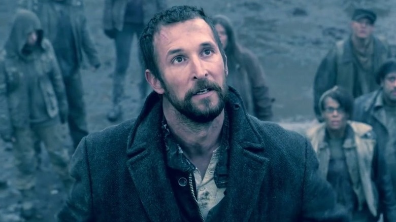 Tom Mason standing in front of people and looking up