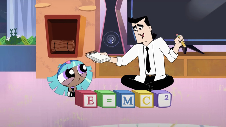 A young Bliss and Professor Utonium sitting together behind a set of blocks that read "E=MC2" while Professor Utonium holds a pad and pencil