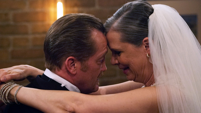 Randall "Mouch" McHolland (Christian Stolte) and Chicago P.D.'s Trudy Platt (Amy Morton) embrace at their wedding reception at Molly's Pub in Chicago Fire