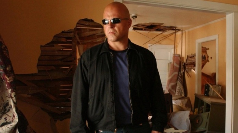 Vic Mackey, wearing sunglasses, stands in a messy room on "The Shield"