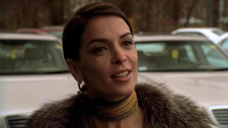 Annabella Sciorra as Gloria Trillo, speaking in front of cars in The Sopranos.