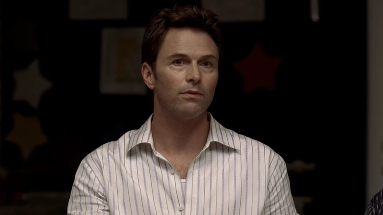 Tim Daly as J.T. Dolan, sitting in the meeting in The Sopranos.
