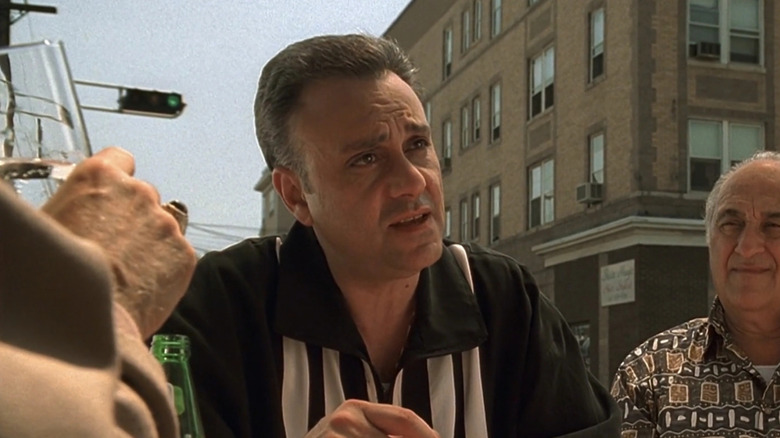 Vincent Curatola as John Sacrimoni, speaking at a table in The Sopranos.