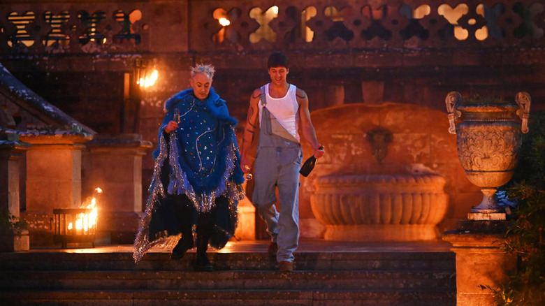 The winner of The Traitors stands with Alan Cumming