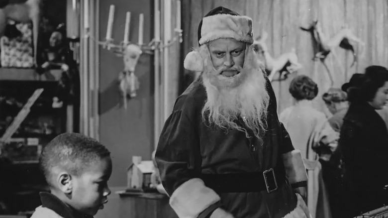 Henry Corwin (Art Carney) stands in a Santa Claus costume in a department store in The Twilight Zone