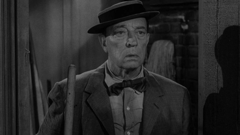 Woodrow Mulligan (Buster Keaton) holds a broom in The Twilight Zone