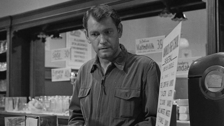 Mike Ferris (Earl Holliman) stands quizzically behind a bar in The Twilight Zone