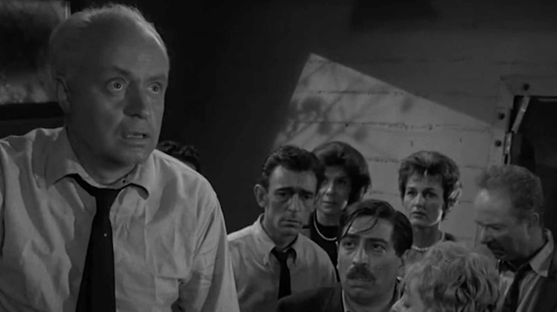 Dr. Bill Stockton (Larry Gates) reckons with a potential nuclear bomb with his party guests in The Twilight Zone, The Shelter