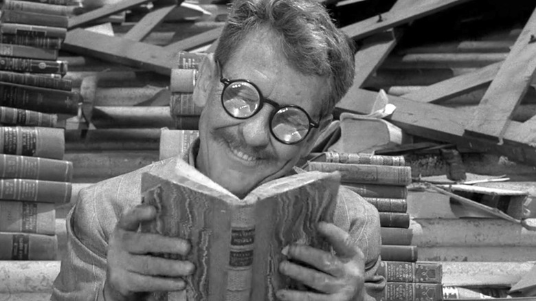 Henry Bemis (Burgess Meredith) reads a book in The Twilight Zone, Time Enough at Last