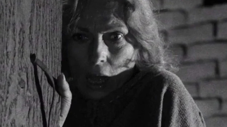 A woman in a farmouse, played by Agnes Moorehead, begins a violent interaction with two beings in a spaceship