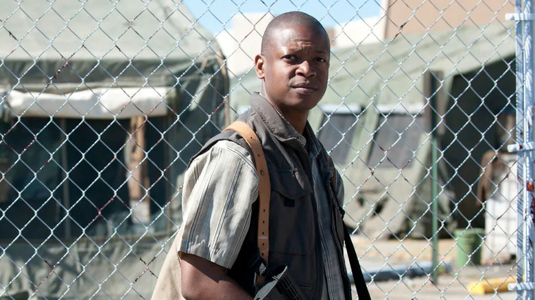Lawrence Gilliard Jr. as Bob Stookey, standing near a fence in The Walking Dead.