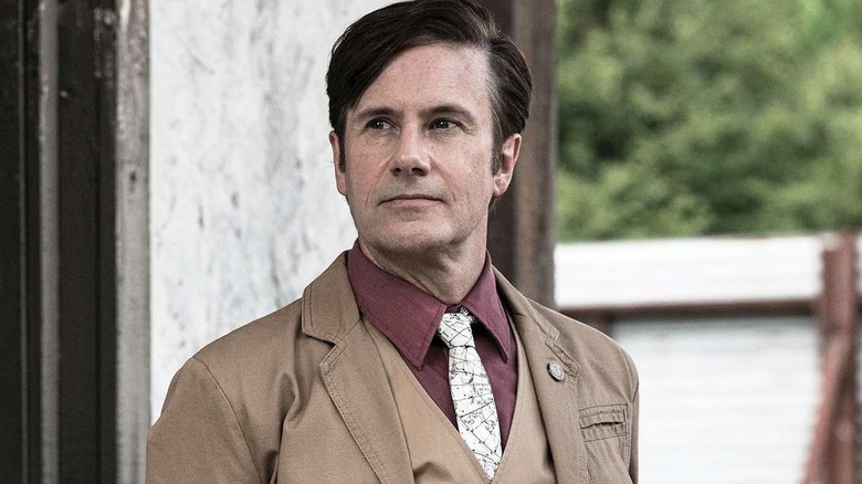 Josh Hamilton as Lance Hornsby, dressed nicely and standing outside in The Walking Dead.