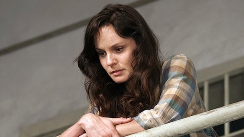 Sarah Wayne Callies as Lori Grimes, looking over a railing in The Walking Dead.