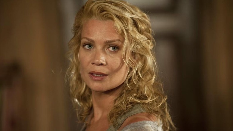 Laurie Holden as Andrea Harrison looks over her shoulder in The Walking Dead