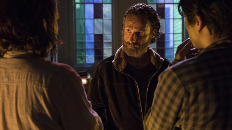 Rick Grimes (Andrew Lincoln) speaks with Maggie Rhee (Lauren Cohan) and Glenn Rhee (Steven Yeun) in a church on The Walking Dead