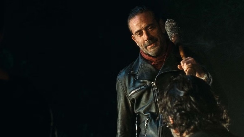 A jeering Negan (Jeffrey Dean Morgan) stands over Rick Grimes (Andrew Lincoln) on The Walking Dead