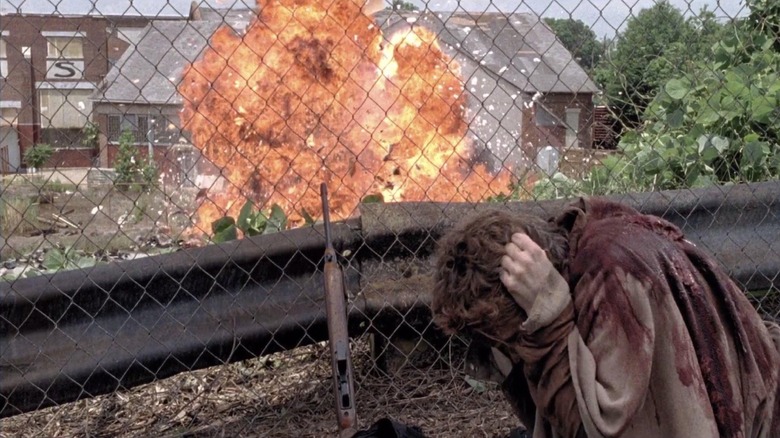 Carol Peletier (Melissa McBride) shields herself from an explosion on The Walking Dead