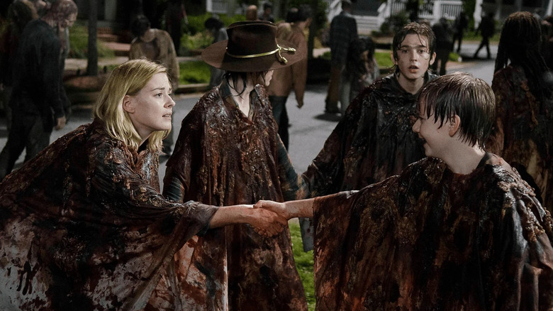 Jessie Anderson (Alexandra Breckenridge) touches an upset Sam Anderson (Major Dodson) in front of Carl Grimes (Chandler Riggs) and Ron Anderson (Austin Abrams) on The Walking Dead