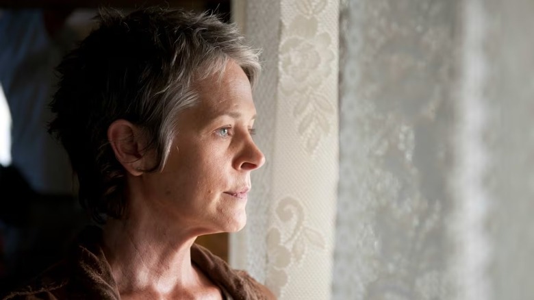 Carol Peletier (Melissa McBride) looks solemnly out a window on The Walking Dead