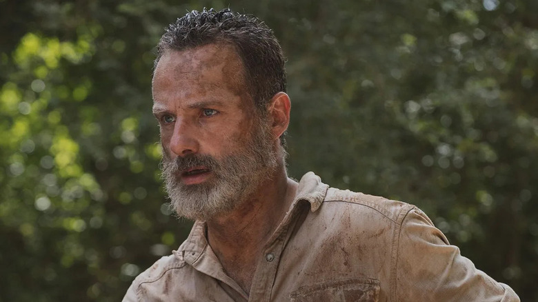 An exhausted and dirty Rick Grimes (Andrew Lincoln) stands outside on The Walking Dead