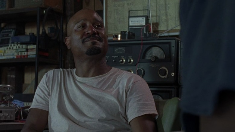 Gabriel sitting on a chair and smiling on The Walking Dead S8E11