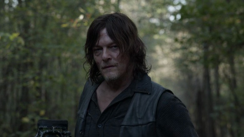 Daryl walking through the woods while staring intently on The Walking Dead S10E21
