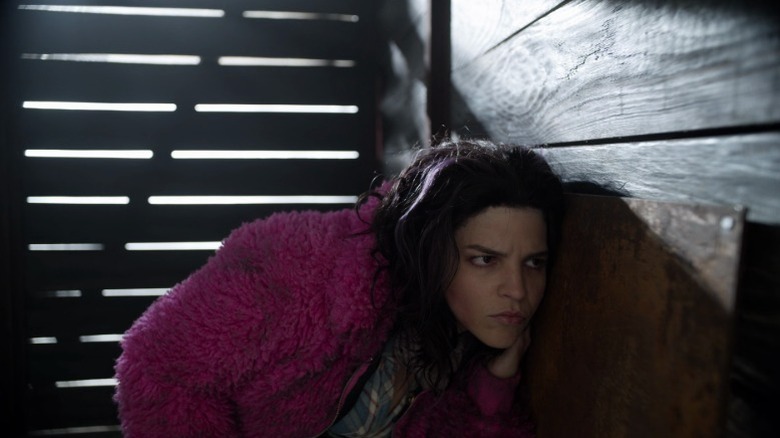 Princess holding her ear up to a wall on The Walking Dead S10E20