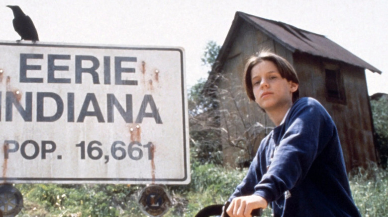 Marshal sitting on his bike next to a town sign on "Eerie, Indiana"